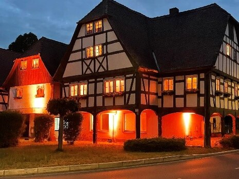 Ein Bild der "Alten Schmiede" am Abend mit stimmungsvoller Beleuchtung.